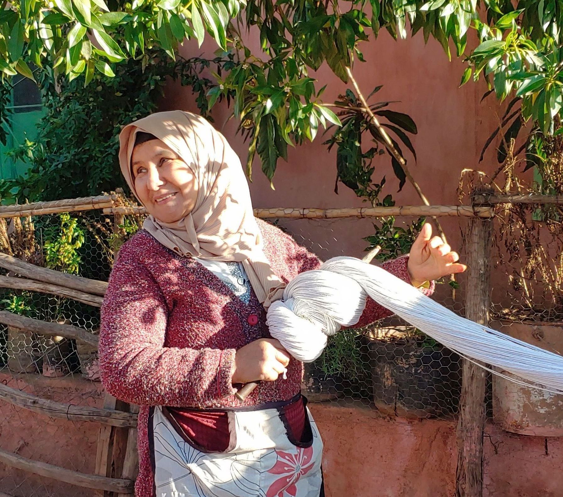 Amazigh woman creating handknitted carpet